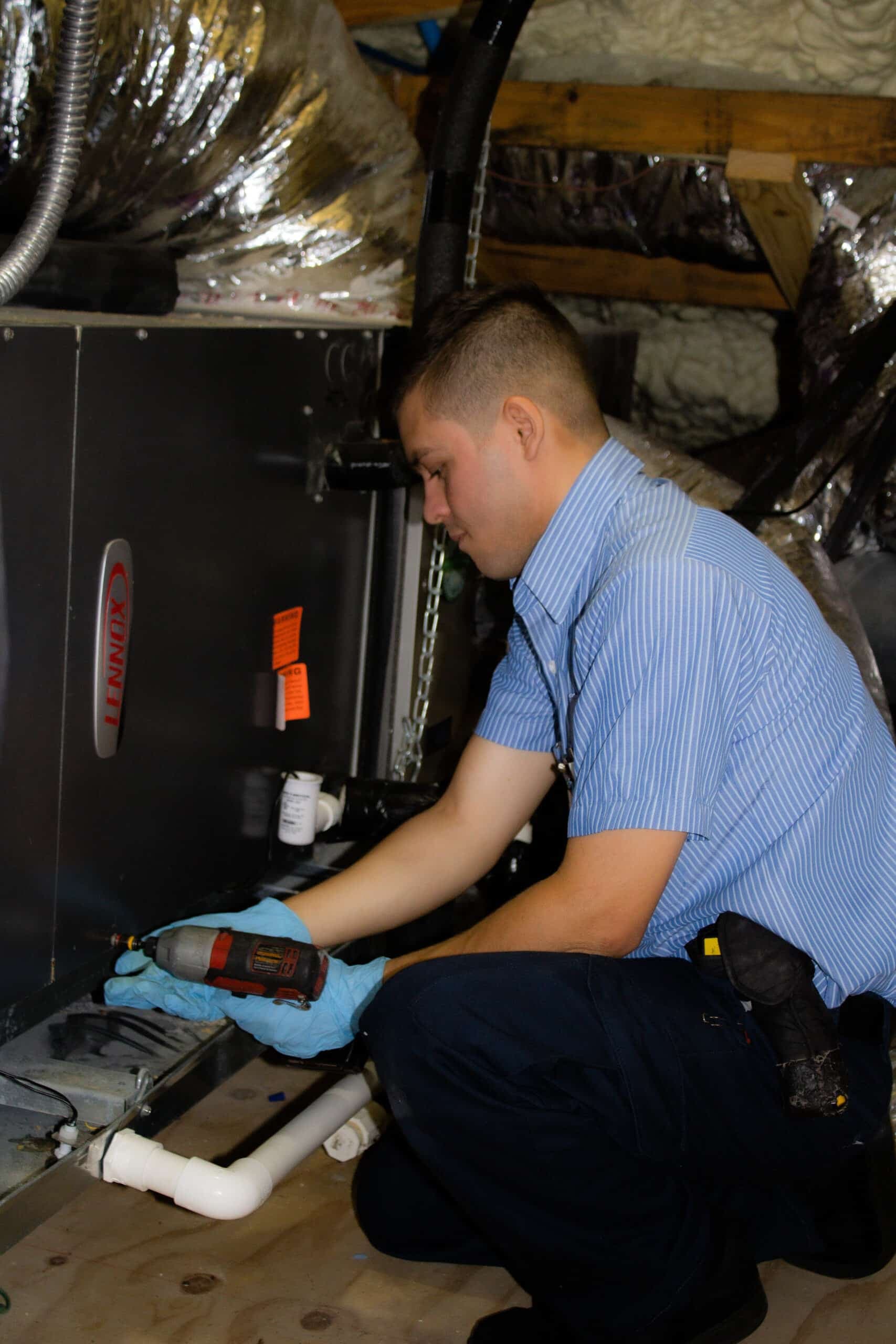 Technician maintaining residential cooling equipment